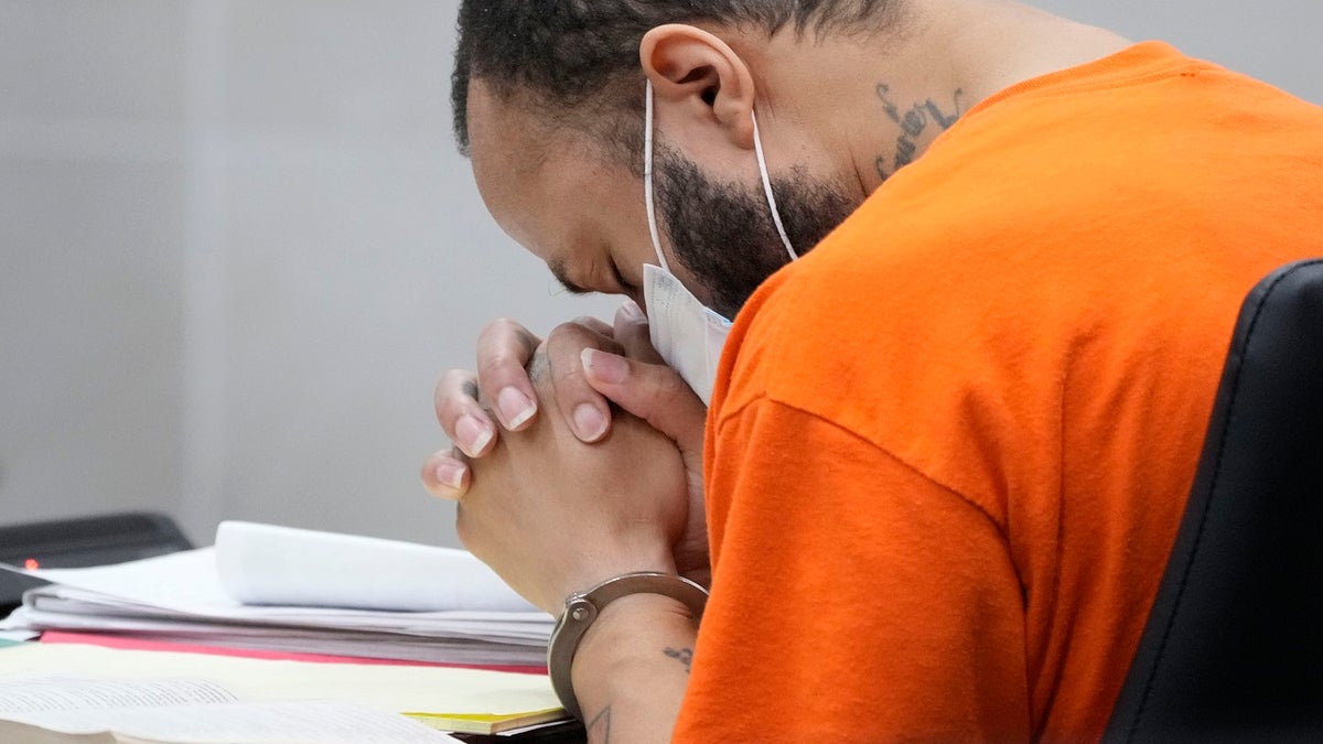 DARRELL BROOKS WITH HANDS IN HEAD IN COURT