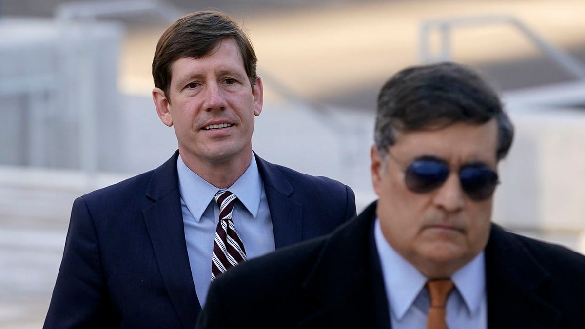 Brian Kelsey in suit and tie outside court