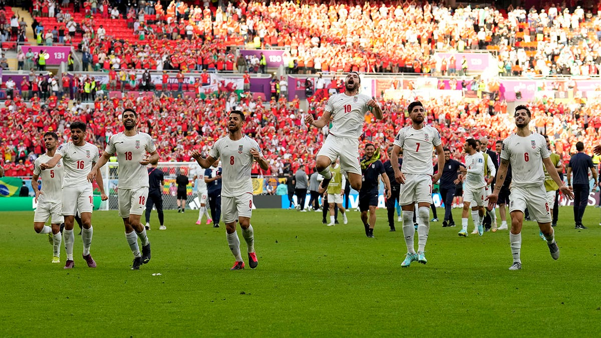 Iran players celebrate beating Wales in the World Cup