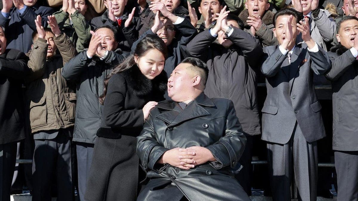 North Korean leader Kim Jong Un, center right, with his daughter, center left