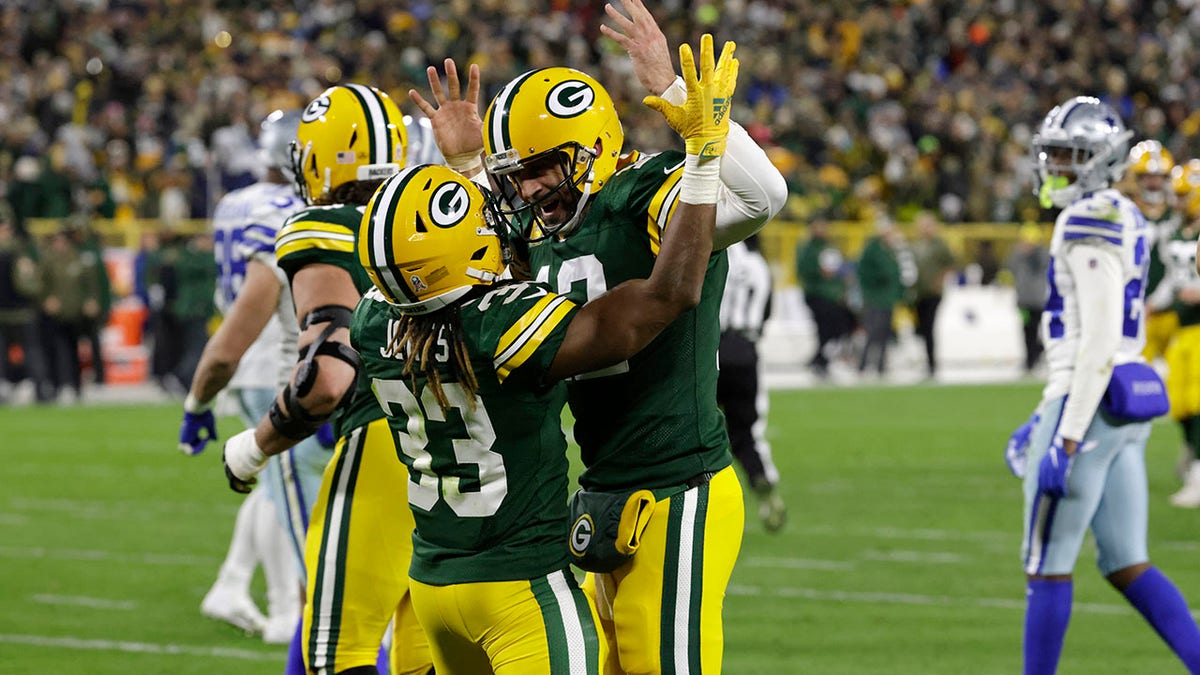 Aaron Jones celebrates with Aaron Rodgers