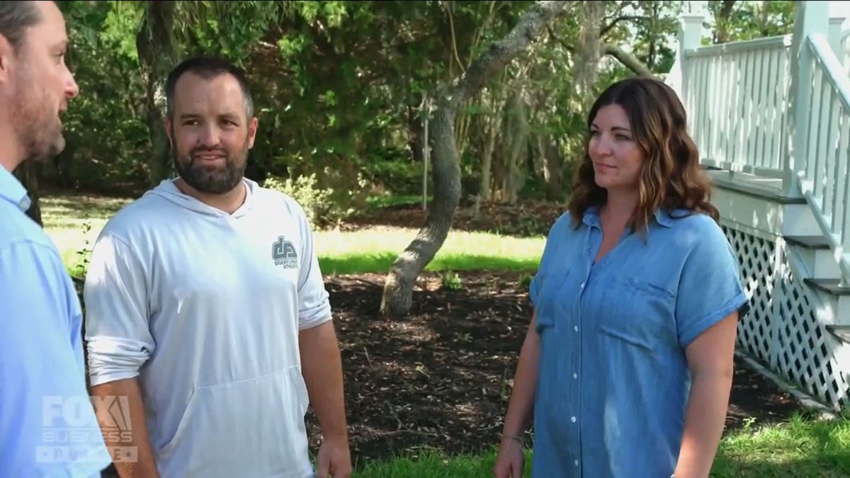 Dustin and Amy discussing the house with their realtor