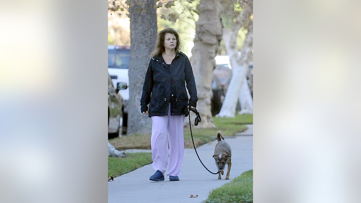 Yasmine Bleeth casually walking her dog