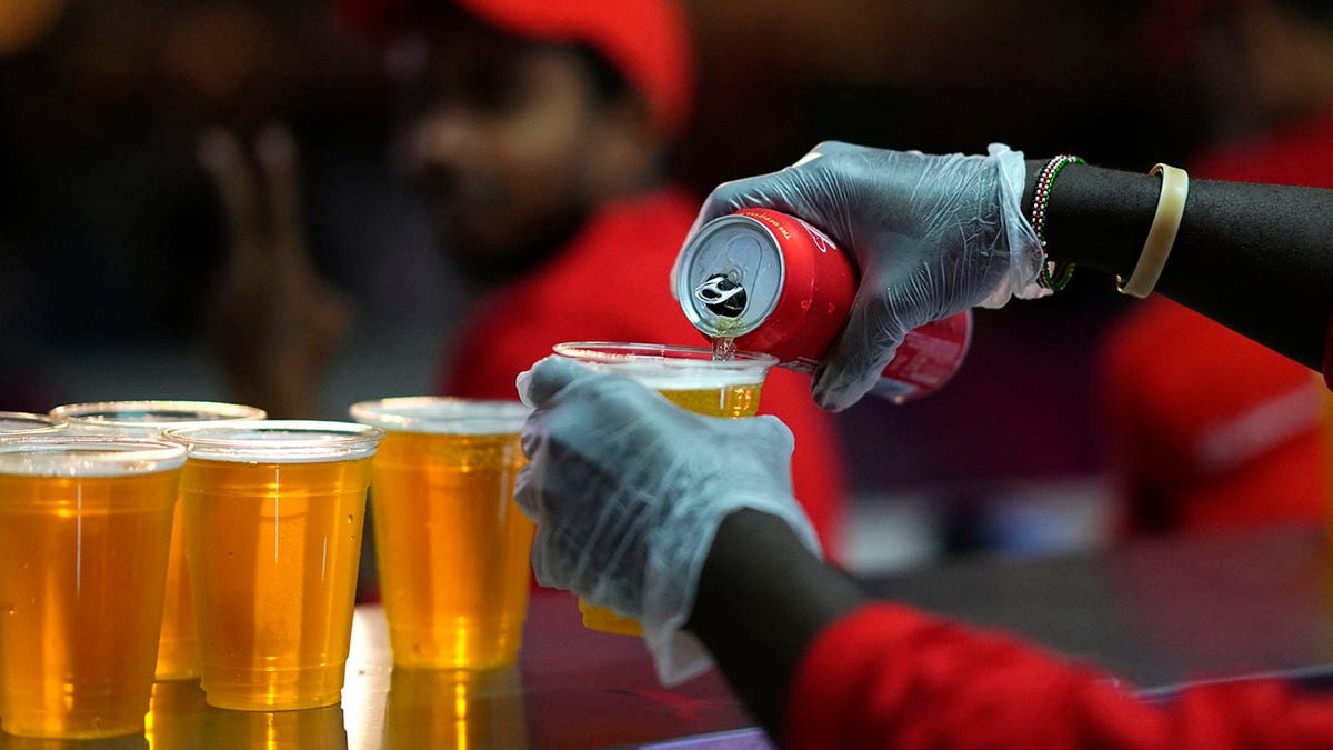 Worker pours beer