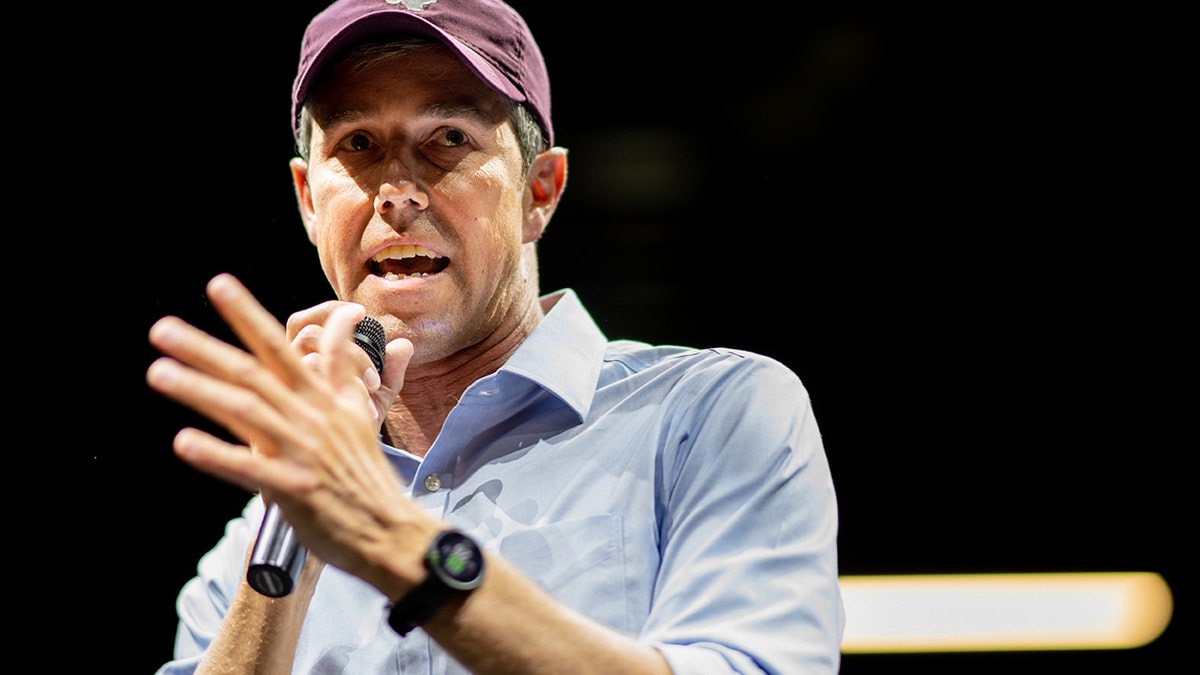 Beto O'Rourke in red hat speaking