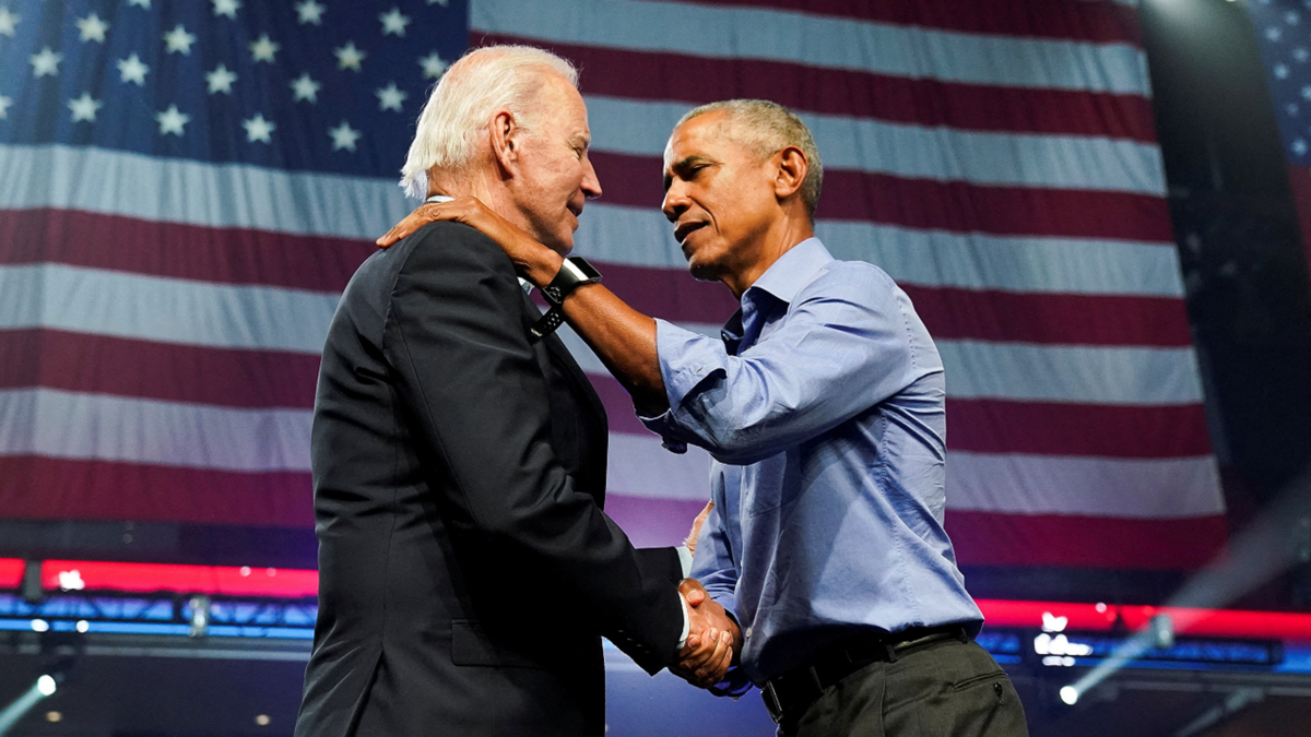 President Biden and former President Obama shake hands