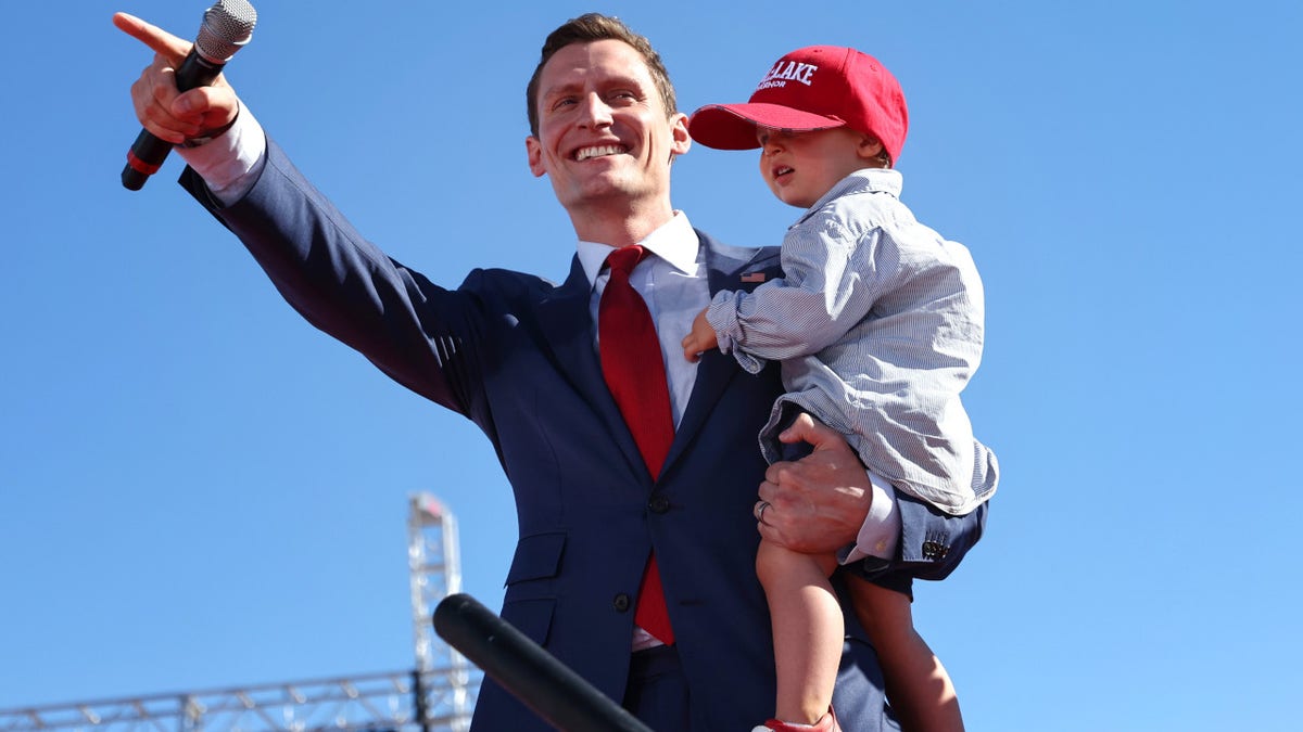 Republican Senate candidate Blake Masters holds his 2-year-old son Rex