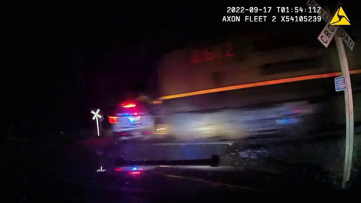 A train is shown slamming into the a police cruiser