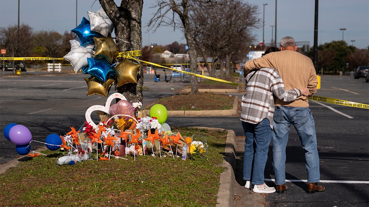 Mourners are seen outside Chesapeake, Virginia Walmart where six were shot and killed