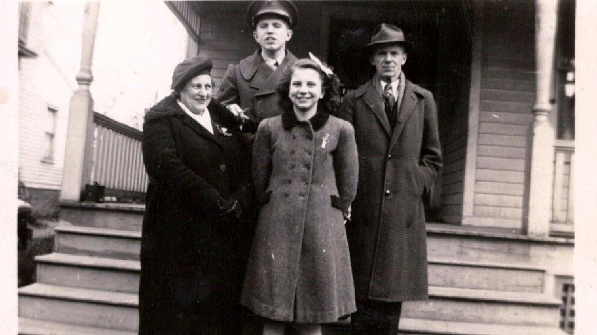 Harold Chilton in his Marine uniform while he stands with his family