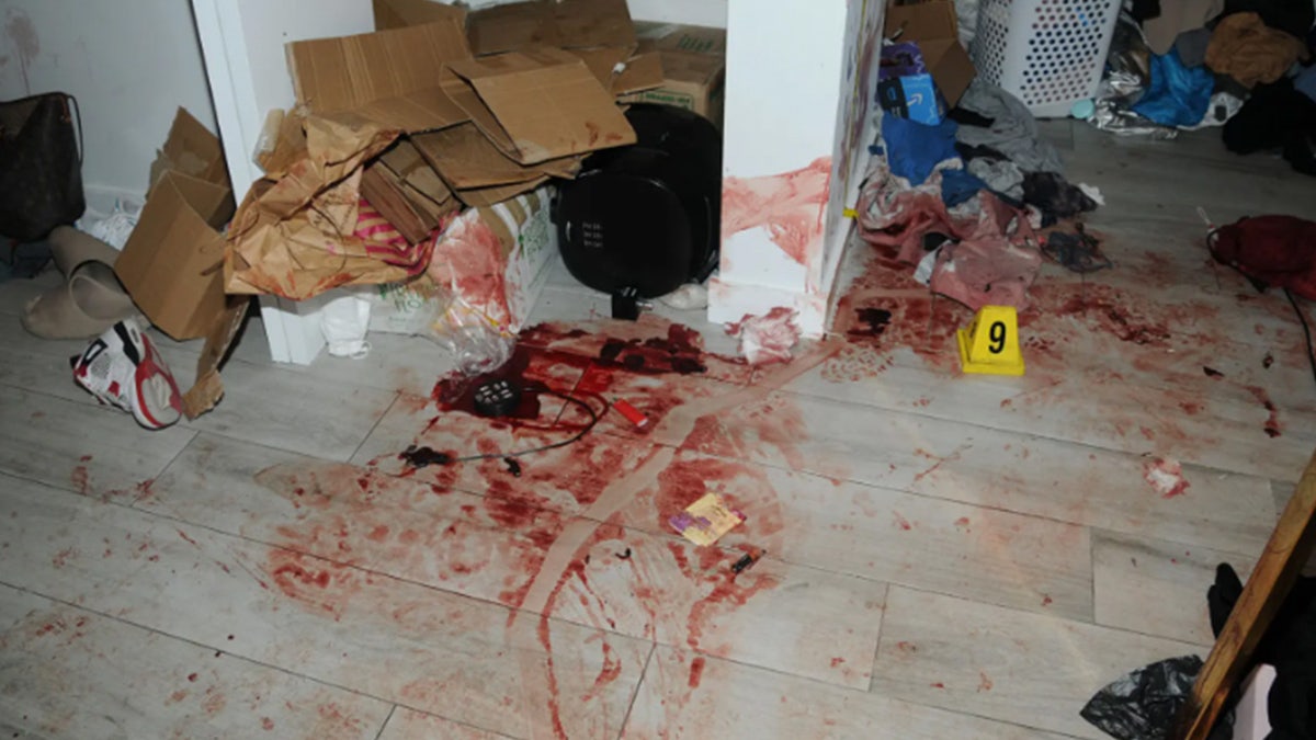 Tile floors, a wall and clothing covered in bloodl.