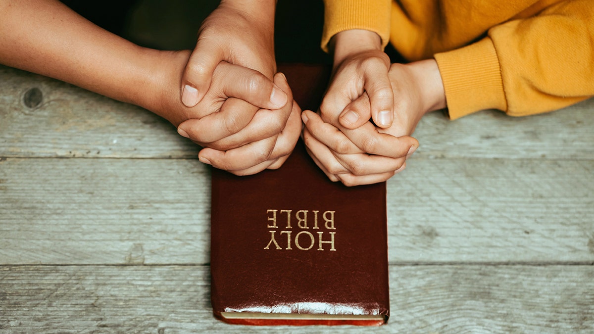 couple praying with bible