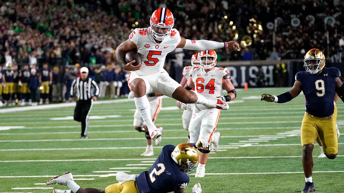 Clemson quarterback hurdles player