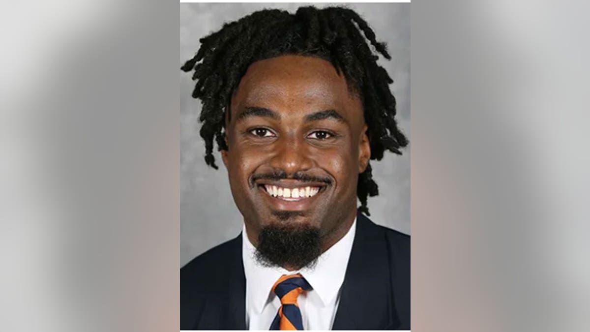 D'Sean Perry smiles in suit