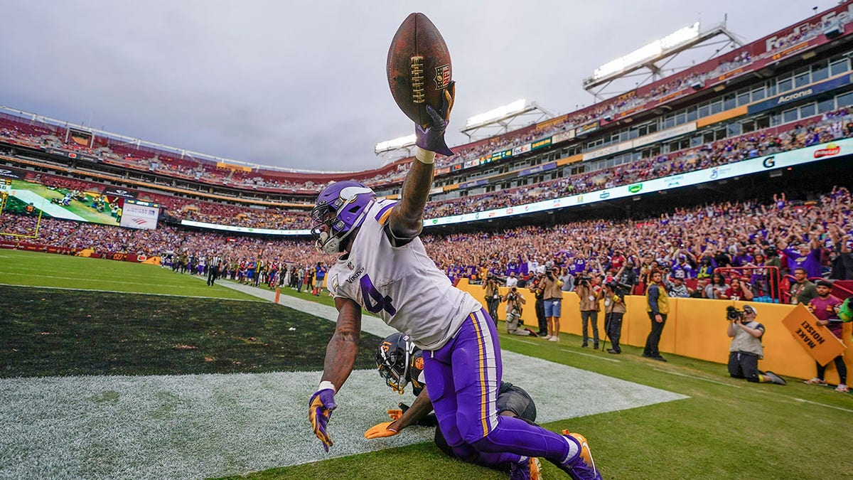 Dalvin Cook holds the football up