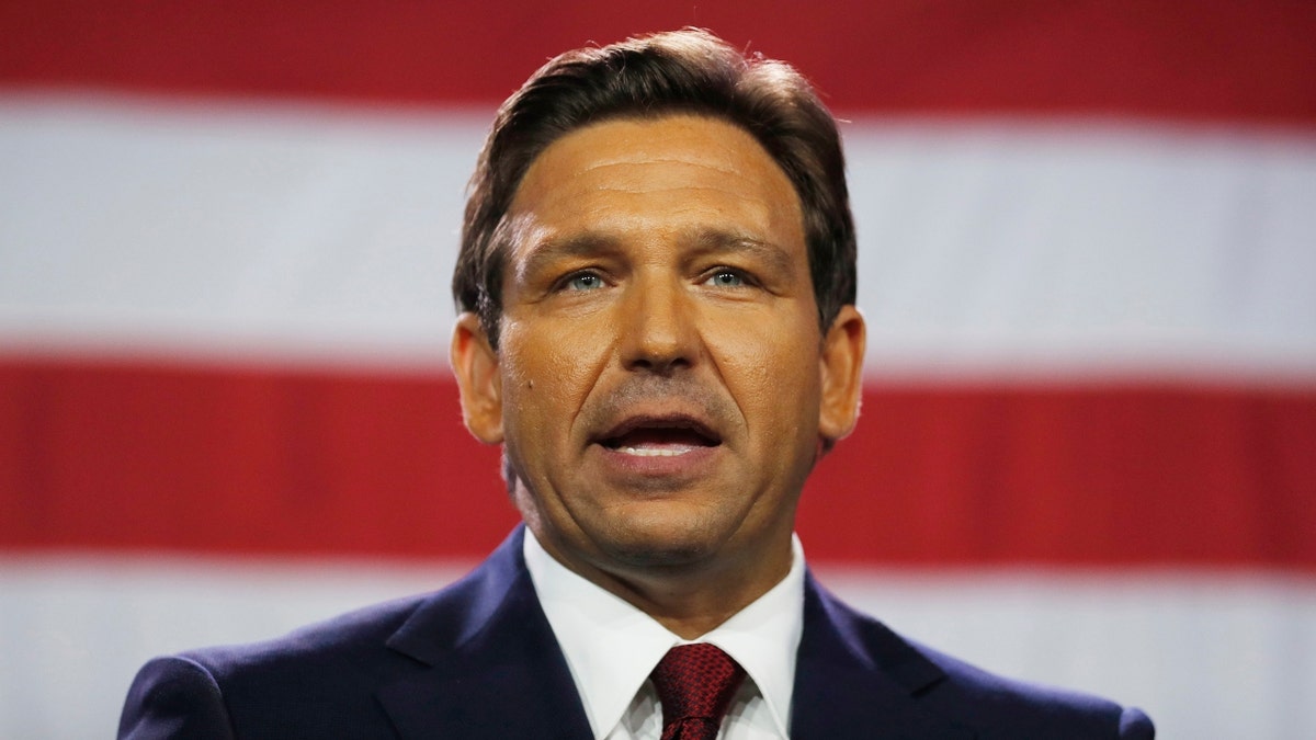 Florida Gov. Ron DeSantis speaking in front of an American flag