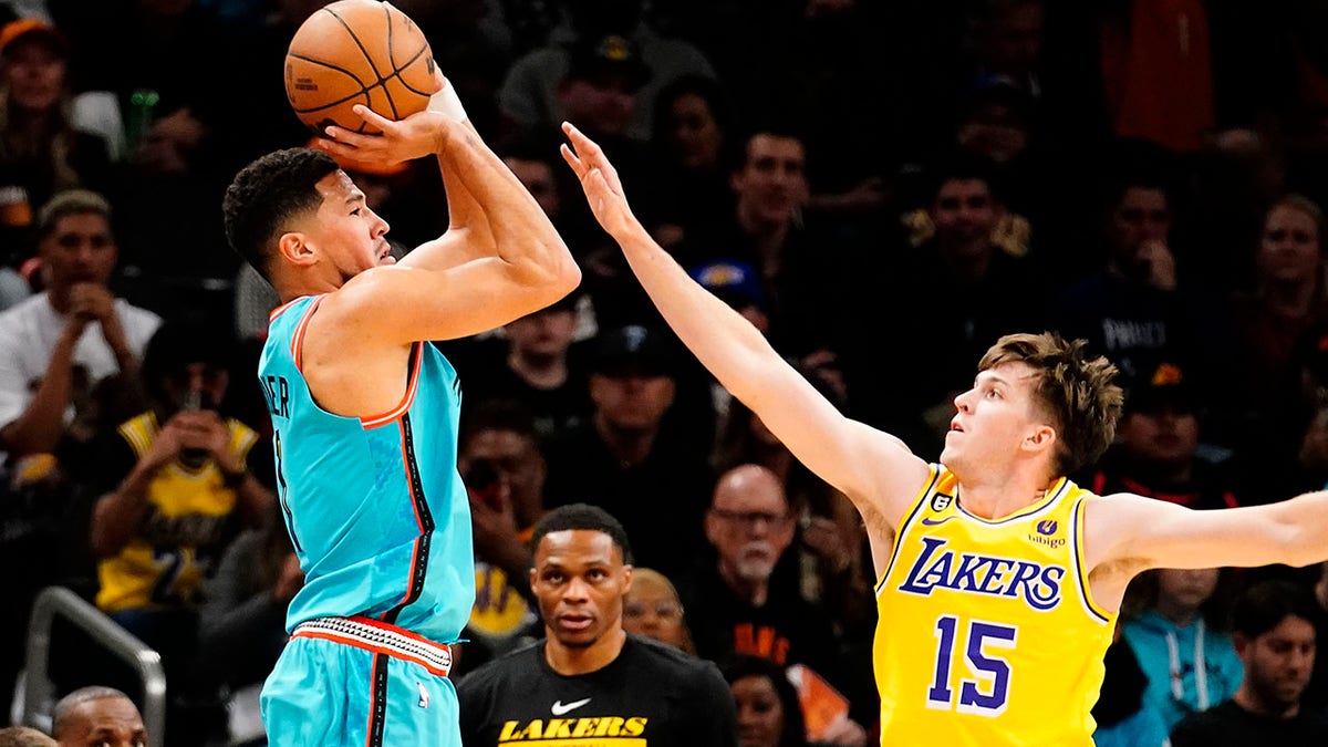 Devin Booker shoots over Austin Reaves