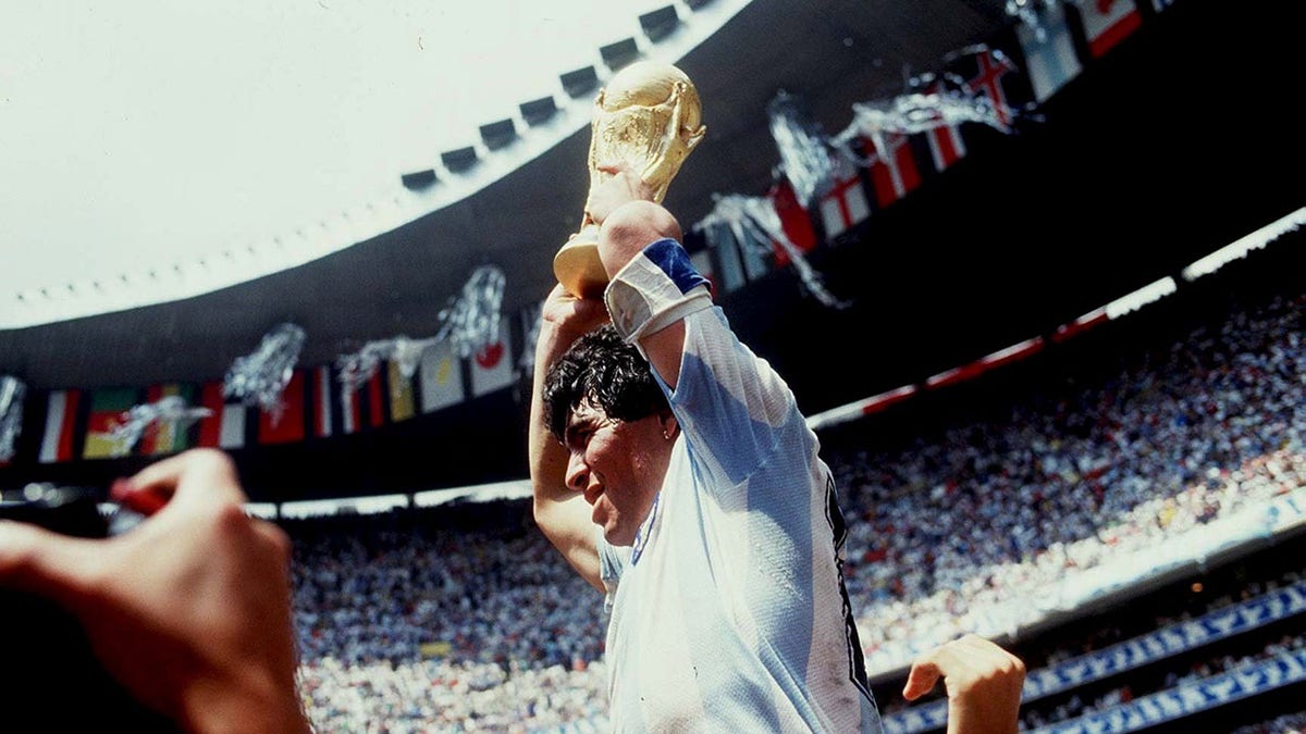 Diego Maradona holds the trophy