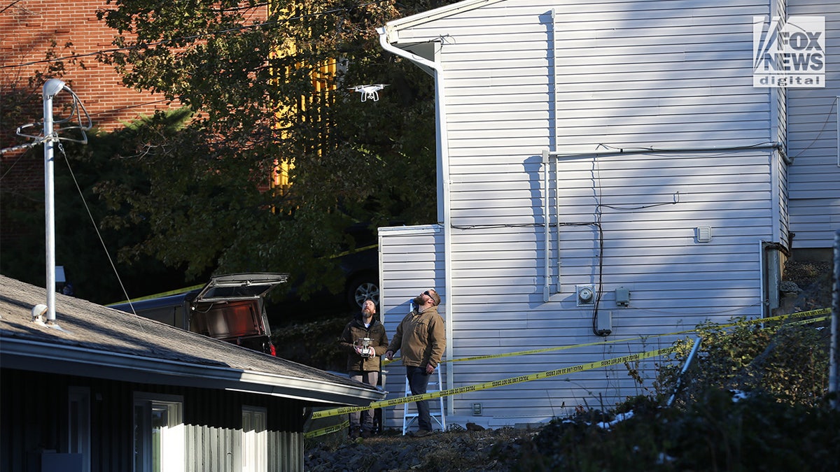 Investigators in front of home