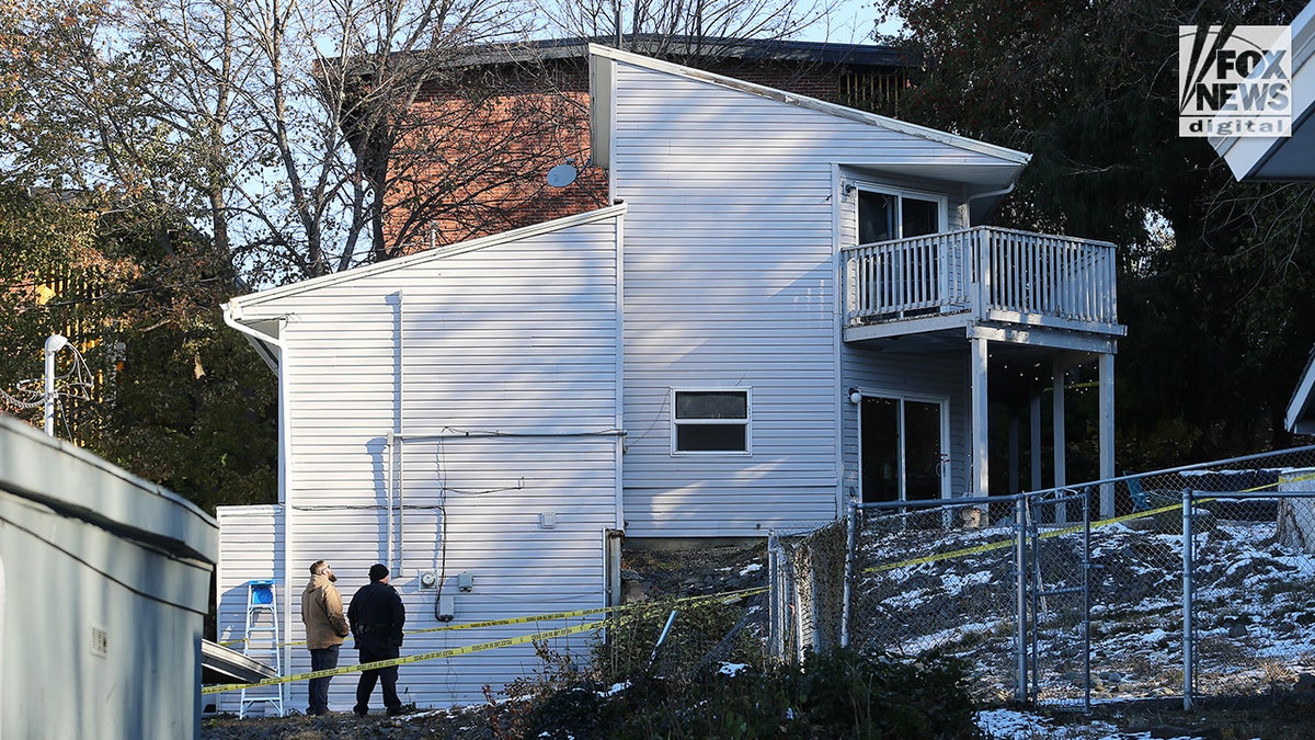 Investigators in front of home