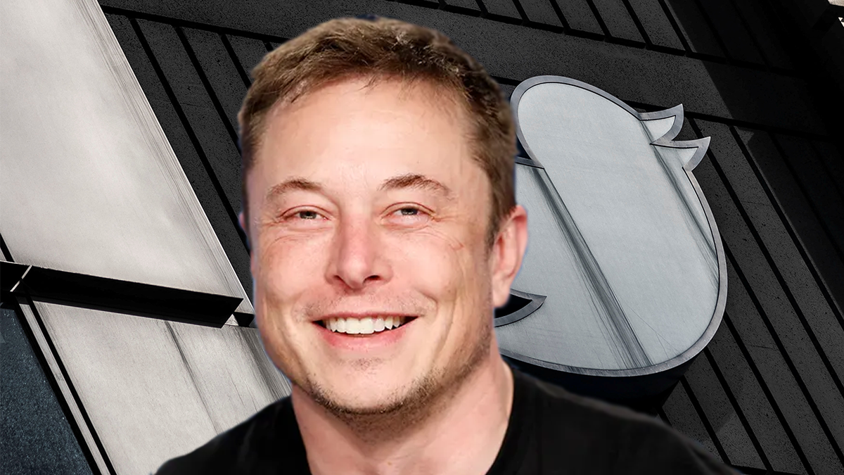 Twitter CEO Elon Musk smiles in front of headquarters