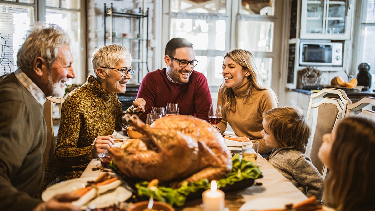 Family gathered the table for Thanksgiving feast