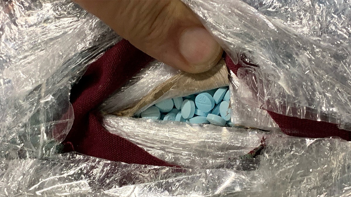 Man shows packaged Fentanyl pills