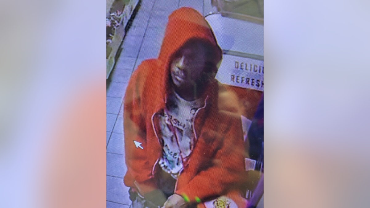 Octavis Wilson wearing an orange hoodie in security footage