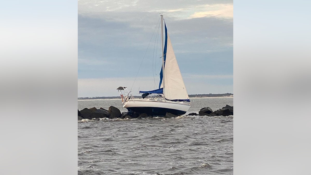 sailboat stranded on jetties