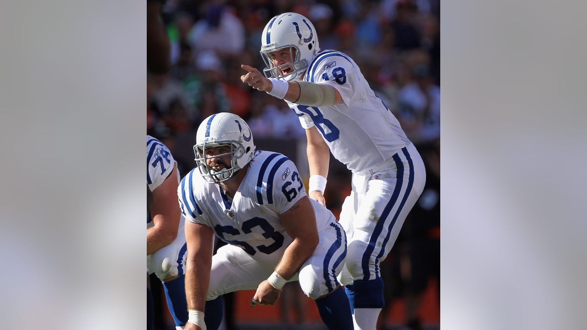 Peyton Manning and Jeff Saturday line up during a game vs the Broncos