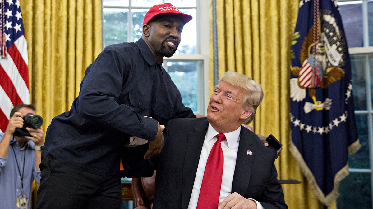 Ye and Donald Trump shaking hands