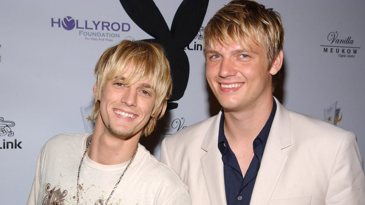 Nick and Aaron Carter pose on the red carpet together at the Playboy Mansion