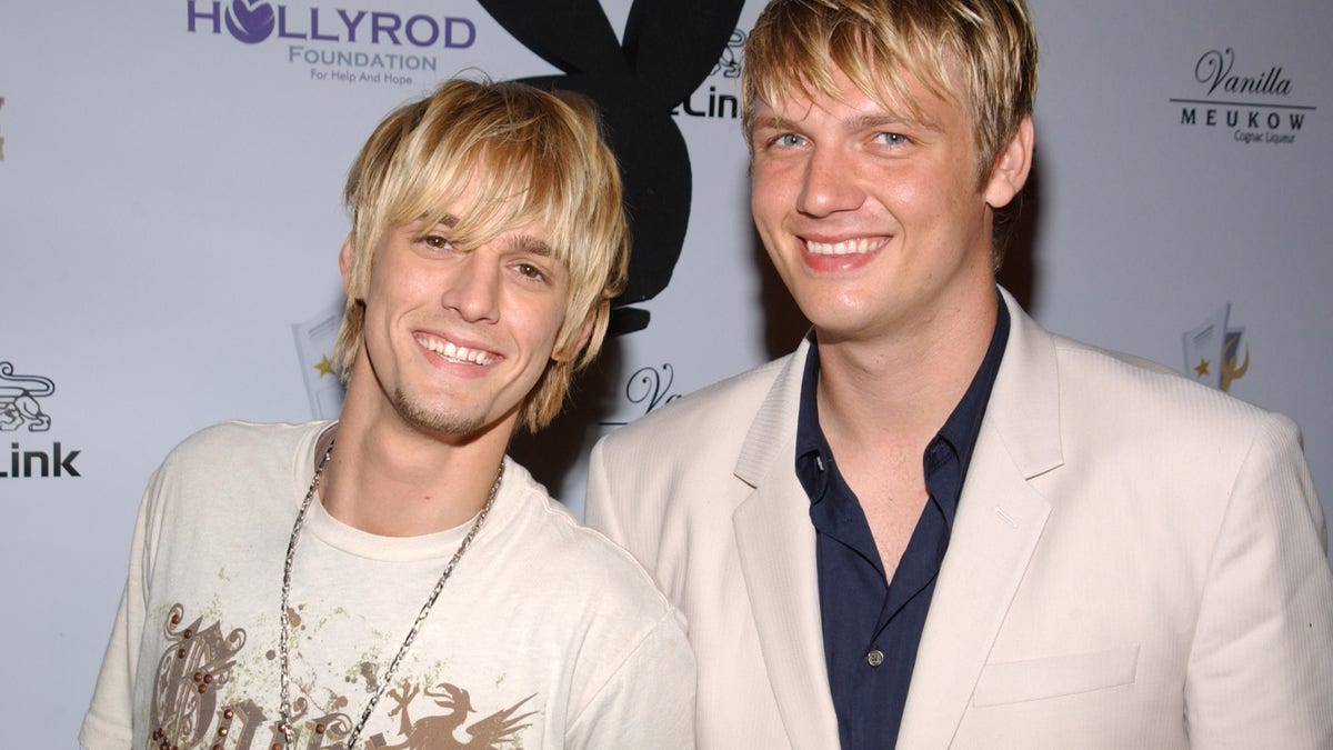 Nick and Aaron Carter pose on the red carpet together at the Playboy Mansion