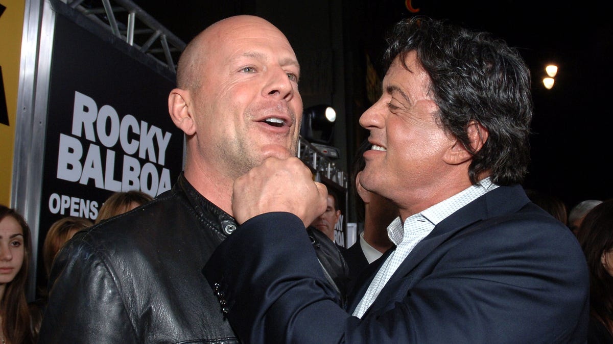 Sylvester Stallone fakes a jab on Bruce Willis