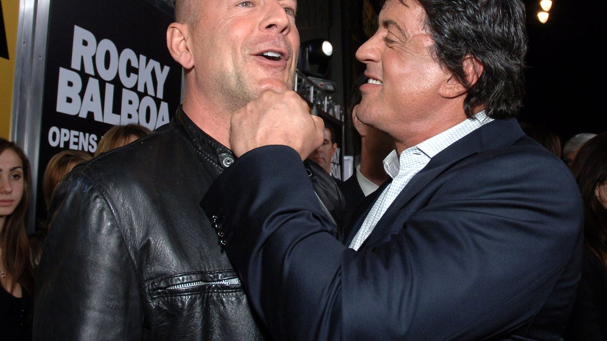 Sylvester Stallone fakes a jab on Bruce Willis