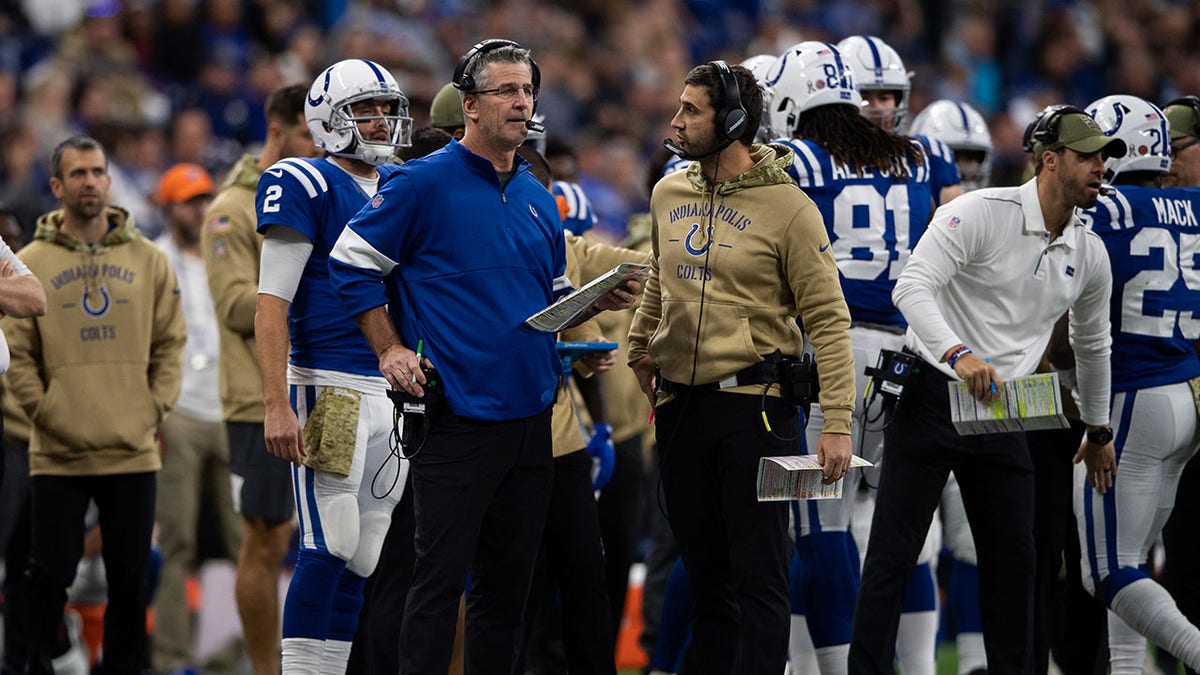 Frank Reich and Nick Sirianni stand together on the sideline