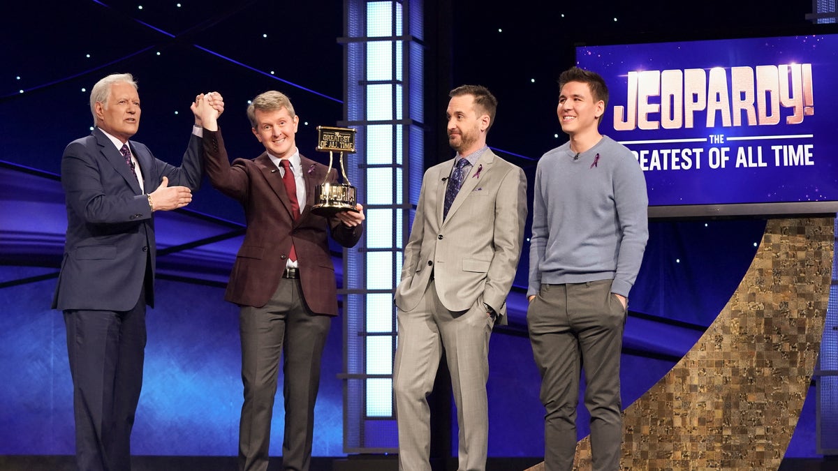 Ken Jennings on the show "Jeopardy!" alongside Alex Trebek and others