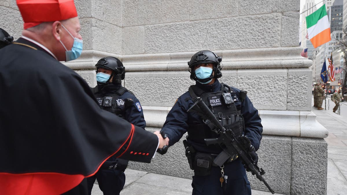 cardinal dolan greeting officers outside church