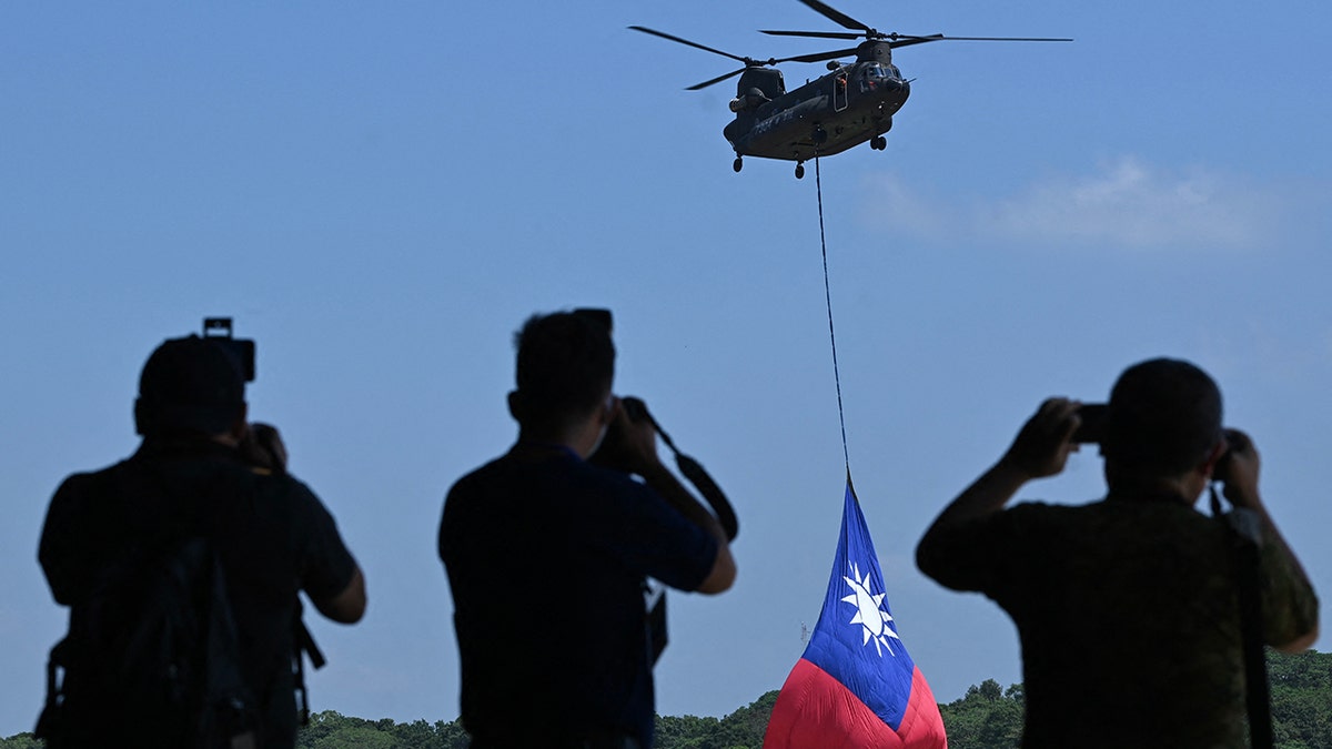 Taiwanese officials looking at a helicopter