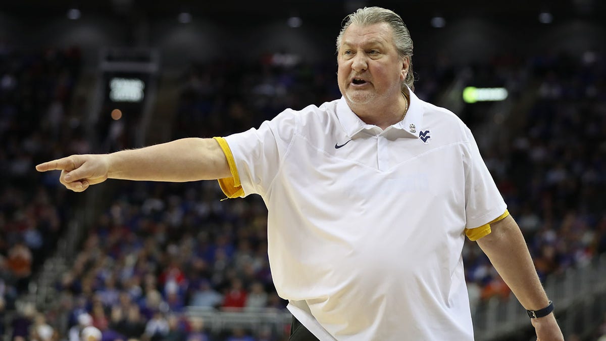 Bon Huggins of West Virginia coaches against Kansas