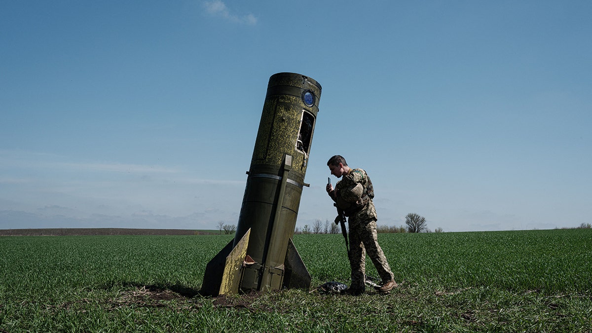 A soldier eyes a rocket