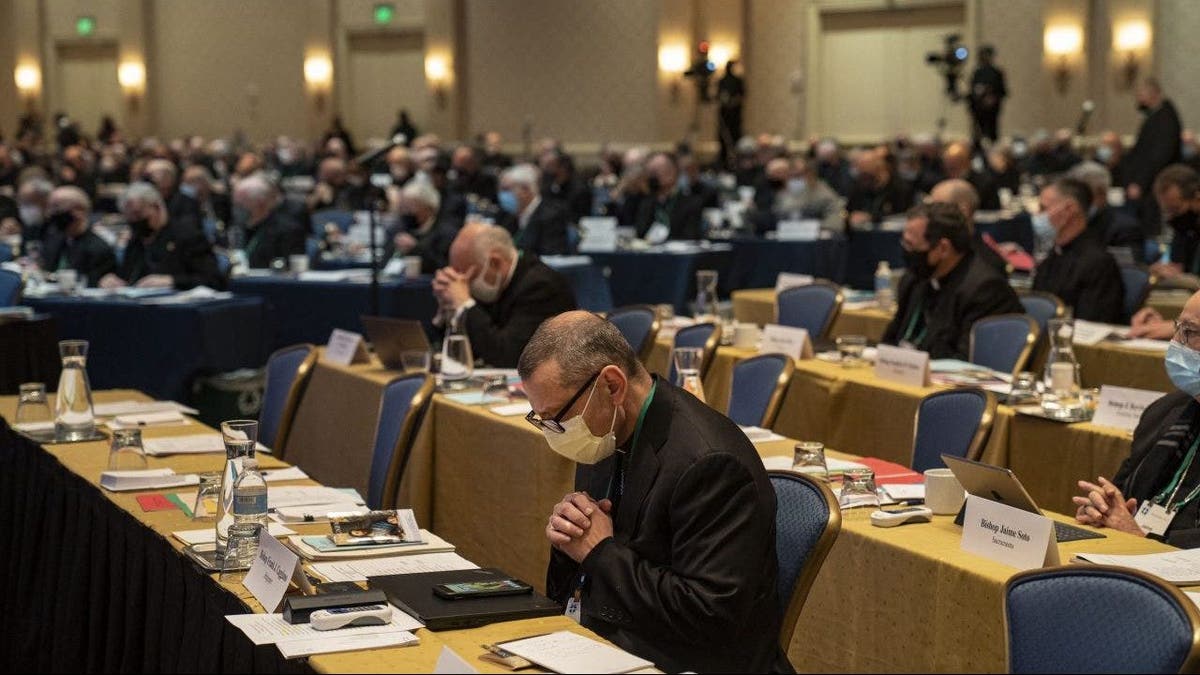 Members of the US Conference of Catholic Bishops pray during meeting