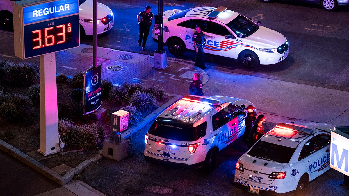 A photo of several police cars with red and blue lights