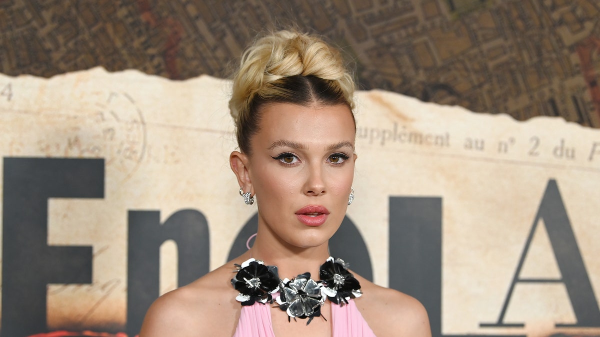 Millie Bobby Brown in "Enola House 2" Premiere wearing pink dress with braided updo