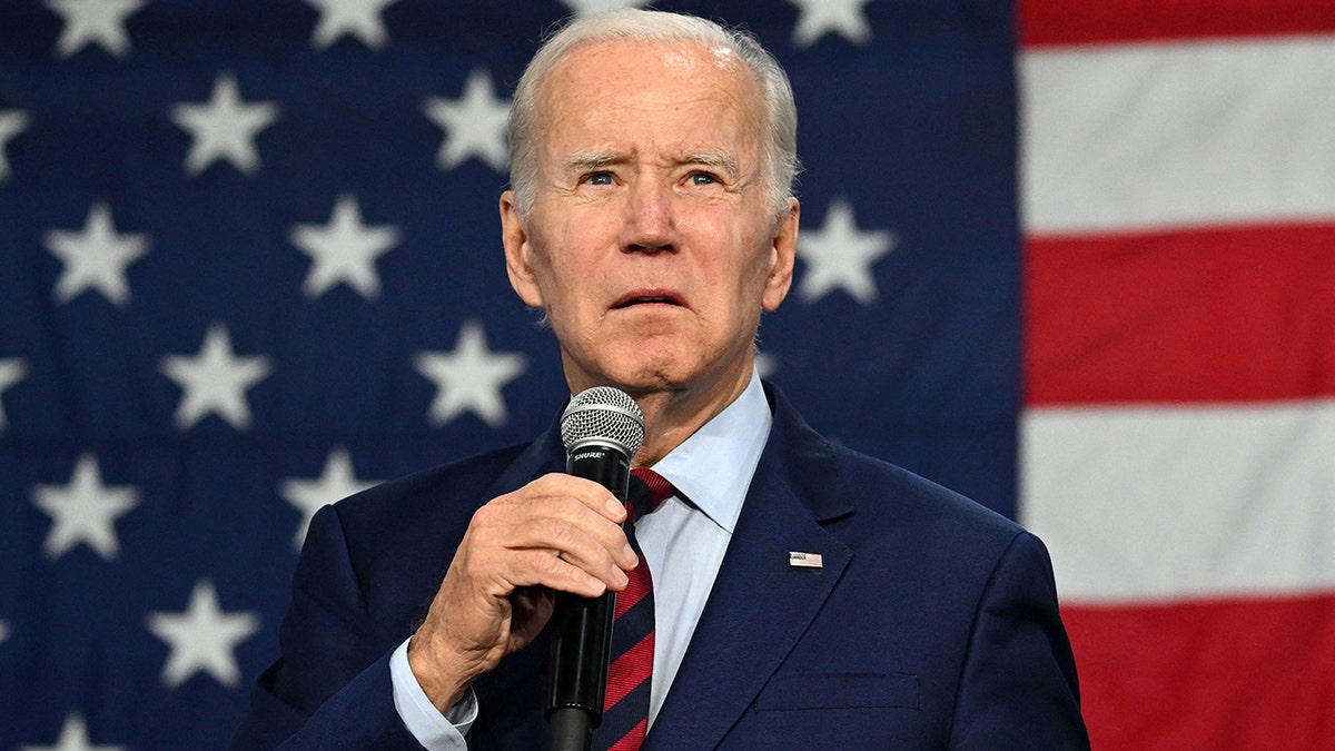 Joe Biden holding a microphone