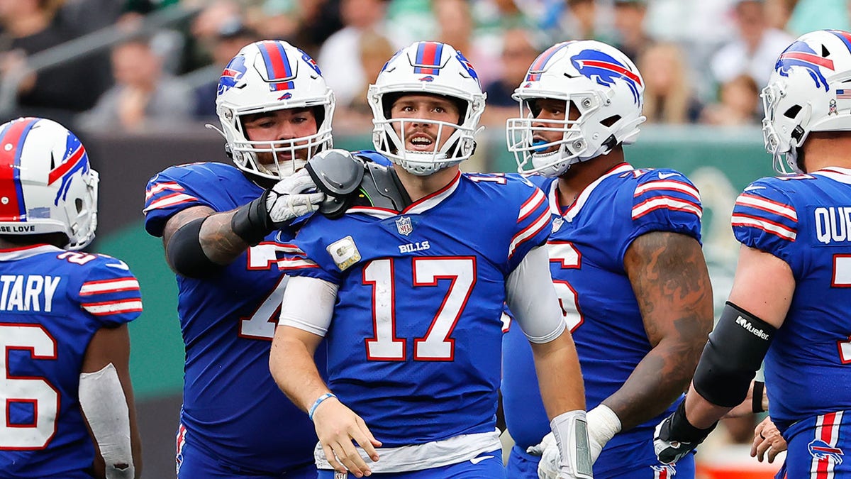 Josh Allen surrounded by Bills players on the field at MetLife