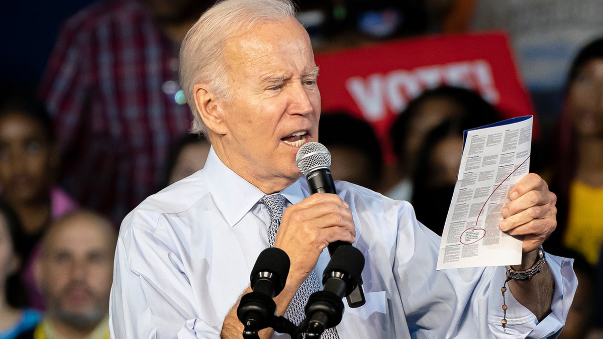 Joe Biden reading from a pamphlet