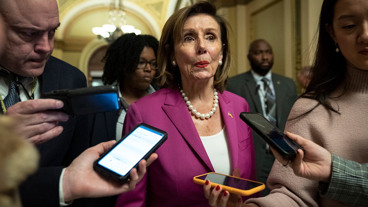 Pelosi surrounded by reporters