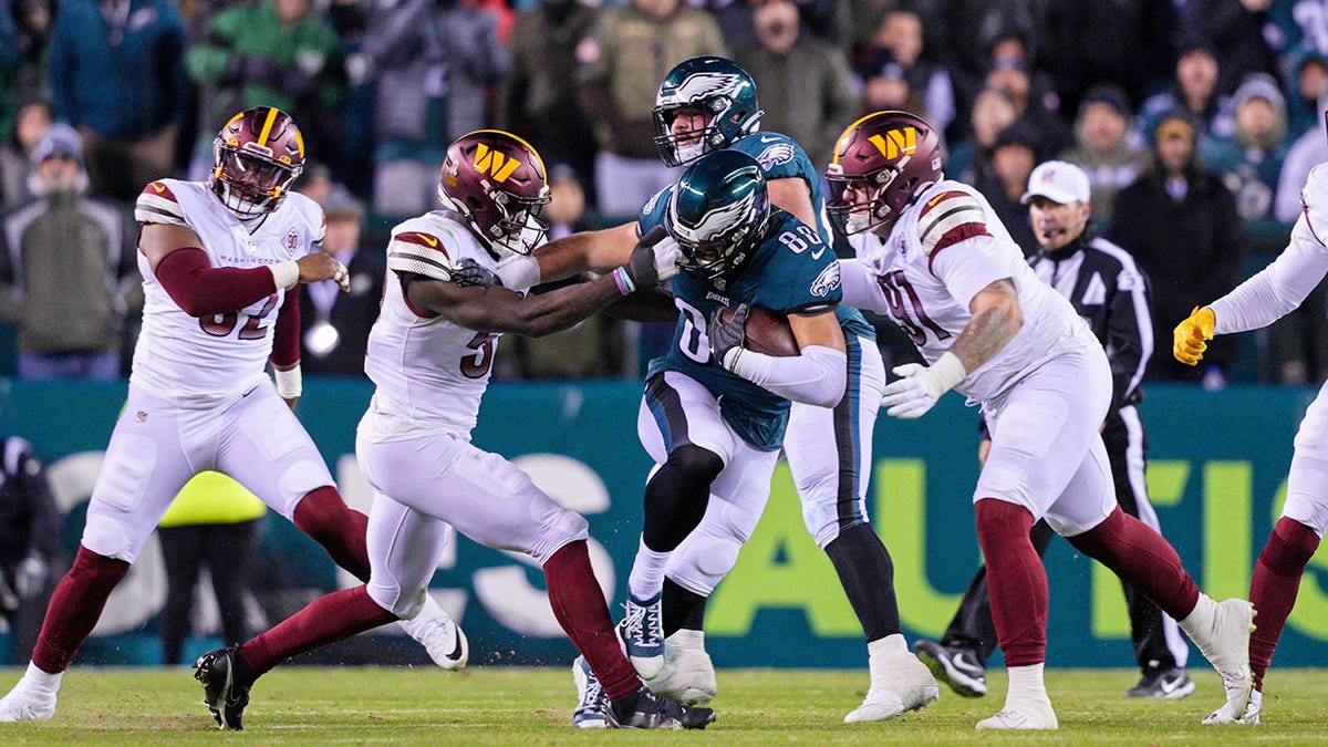 Dallas Goedert fumbles after getting his face mask pulled