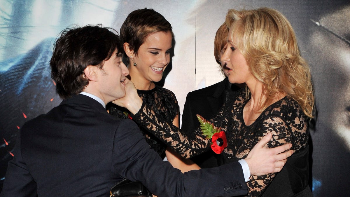 Daniel Radcliffe goes to give J.K. Rowling a hug on the red carpet